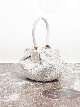 Ivory Nappa Leather Nina Bag with Cotton Macramé on Marble Surface - Styled Look | Gabriela Hearst