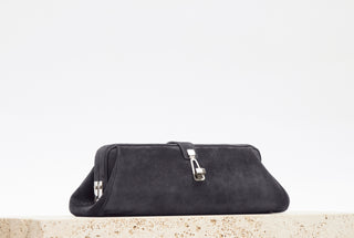 Dark Grey Suede Paola Clutch - Styled on Stone Surface | Gabriela Hearst