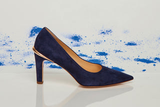 Navy Suede Edwina Stiletto Pump - Editorial Side View against Blue Pigment Backdrop | Gabriela Hearst