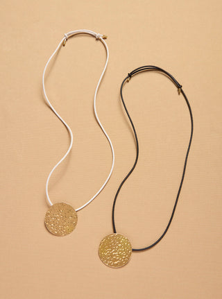 Wheel of Fortune Pendants in White and Black Cord Options - Flat Lay | Gabriela Hearst