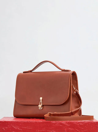 Cognac Calf Leather Large Leonora Satchel - Styled Shot on Red Surface | Gabriela Hearst