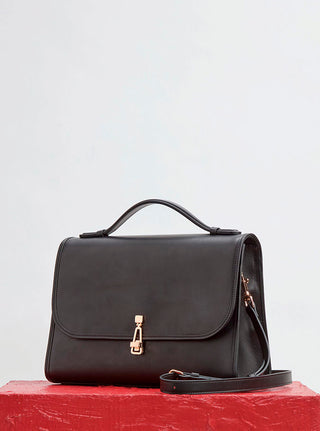 Black Leather Leonora Handbag on Red Surface - Styled Editorial Shot | Gabriela Hearst