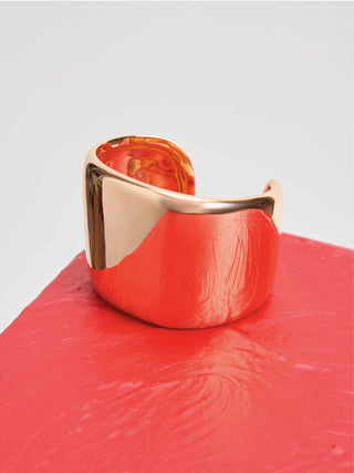 18K Yellow Gold Cuff Bracelet on Coral Surface - Lifestyle Shot | Gabriela Hearst