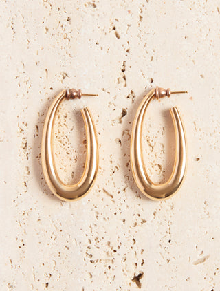 18K Yellow Gold Large Drop Earrings - Flat Lay on Travertine Stone | Gabriela Hearst