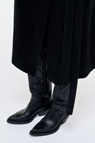 Black Leather Capitana Cowboy Boots Styled On Model with Black Pleated Skirt | Gabriela Hearst