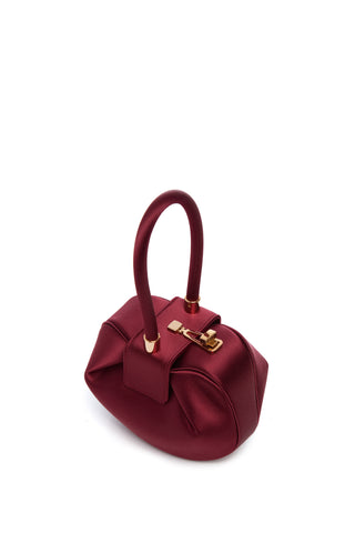 Ruby Satin Demi Bag - Angled View with Rose Gold Turnlock Closure Detail | Gabriela Hearst