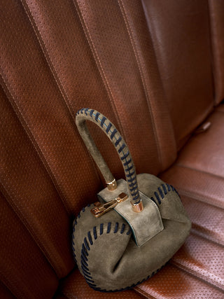 Olive Suede Whipstitch Demi Bag - Styled On Leather Chair | Gabriela Hearst