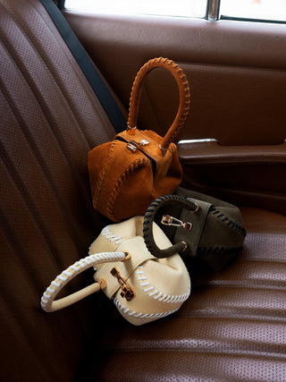 Whipstitch Demi Bags in Nude, Tan and Olive Suede - Three Colorways on Vintage Car Seat | Gabriela Hearst