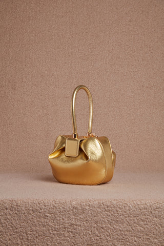 Gold Metallic Nina Bag on Textured Background - Studio Shot | Gabriela Hearst